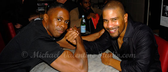 A strange man arm wrestling with David Sanchez